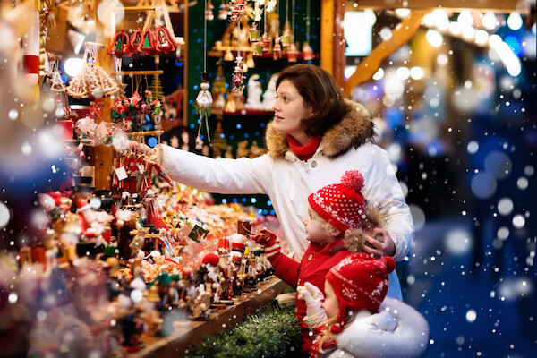 German Christmas market stall and mother with two children