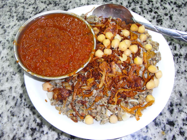 Kushari - egyptisk nationalrätt - serveras på en egyptisk restaurang i Kairo - image by