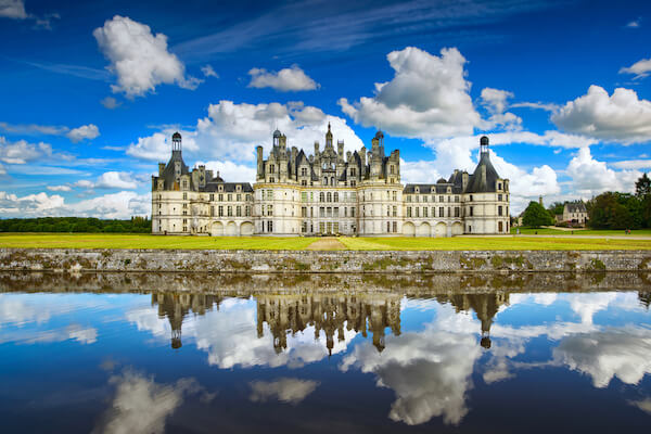 Chambord Castle in France on a sunny day with clouds