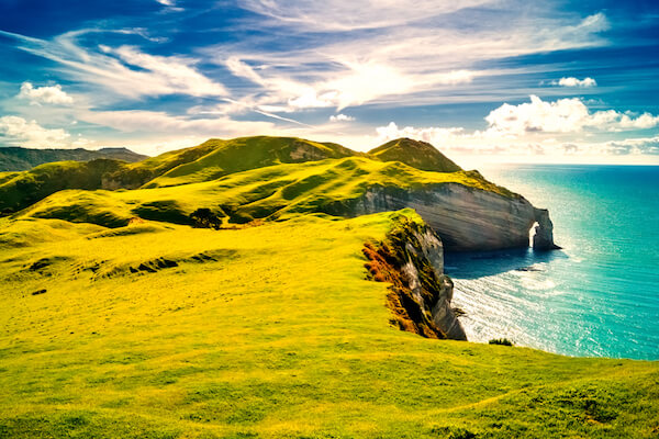 Ireland, nicknamed the Emerald Isle, with white cliffs and turquoise sea in sunshine with some white fluffy clouds