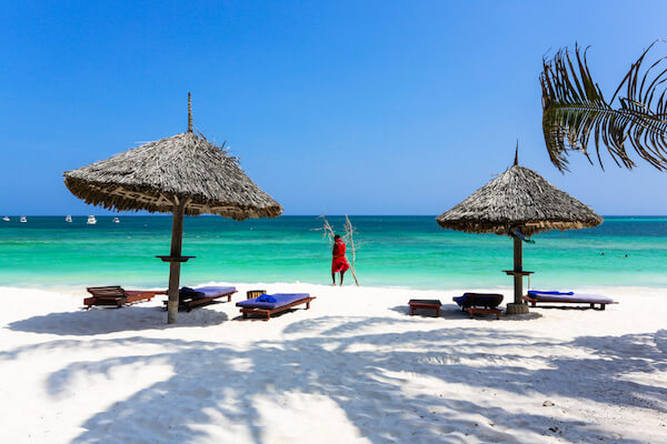 Watamu - Turtle Beach and turquoise sea with Maasai in red dress