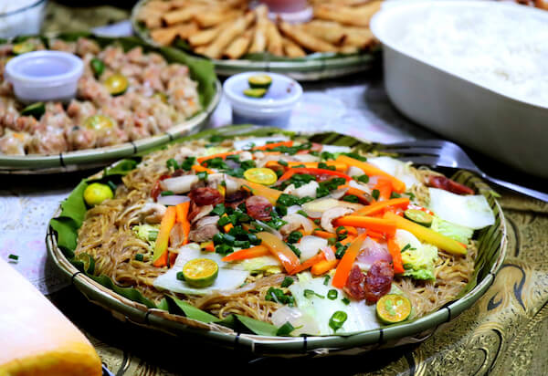 Typical Filipino dishes including pancit or pansit which is a fried noodle dish