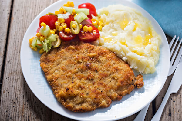 Polish schabowy is breaded cutlet or port chops served with potato mash and salad