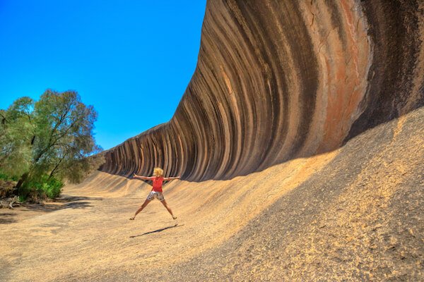 Wave Rock in Australia with jumping teenager