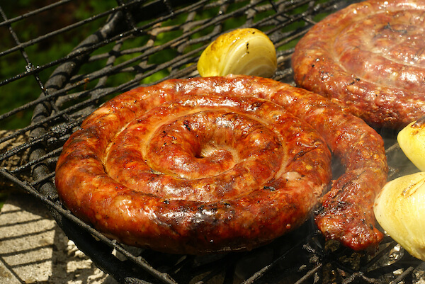 Boerewors shaped as roll on grill