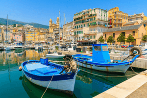 Corsica fishing boats in harbour - image by shutterstock
