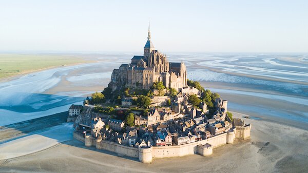 Mont Saint Michel on sandy tidal island at low tide