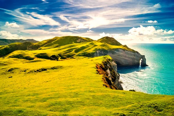 Ireland, nicknamed the Emerald Isle, with white cliffs and turquoise sea in sunshine with some white fluffy clouds