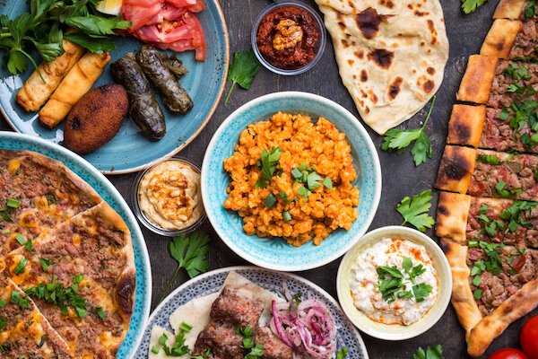 Typical dishes in the Turkish cuisine: Turkish pizza, meat kebab, pita, bulgur, fried meatballs, hummus and turkish meze set.